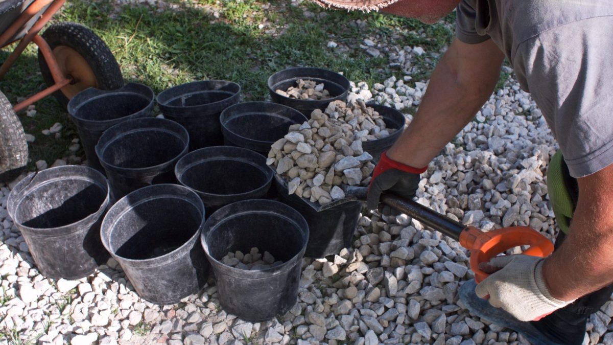 adding gravel to flowerpots